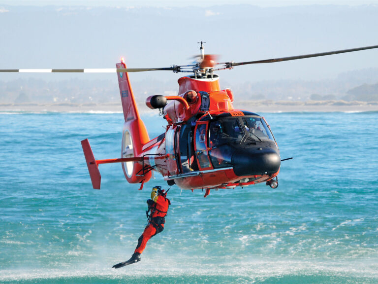 Coast Guard rescue swimmer leaving helicopter