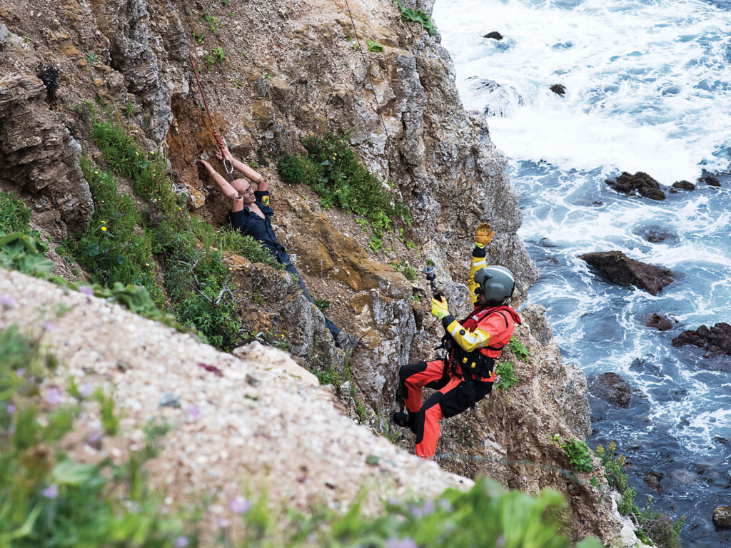 Rescue swimmer practicing cliff rescue