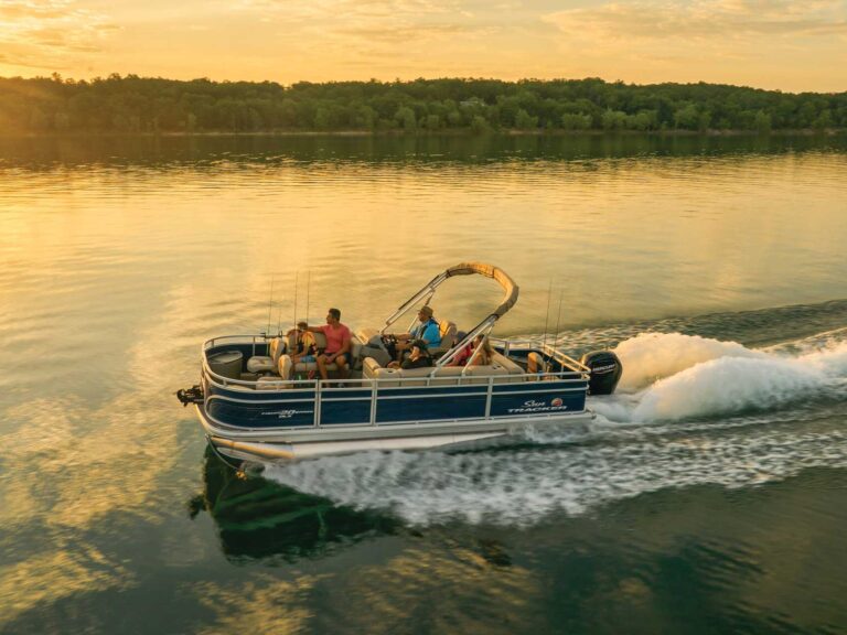 Sun Tracker Party Barge 20 DLX cruising at sunset