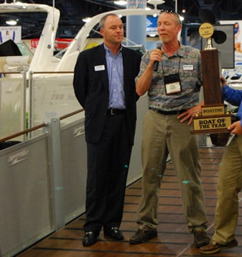 Editor-in-Chief Kevin Falvey awards the 2012 Boat of the Year to Brunswick Boat Group's Andy Graves and Ron Berman for the 370 Venture.