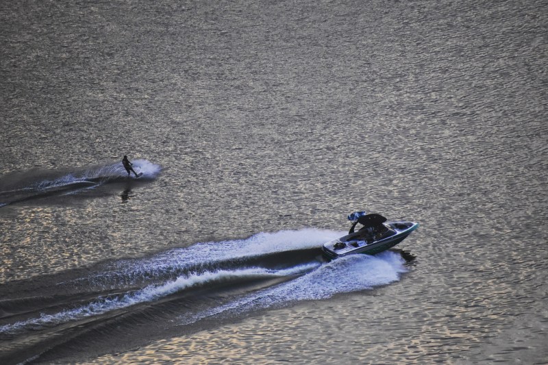 Wakeboarder being pulled across lake