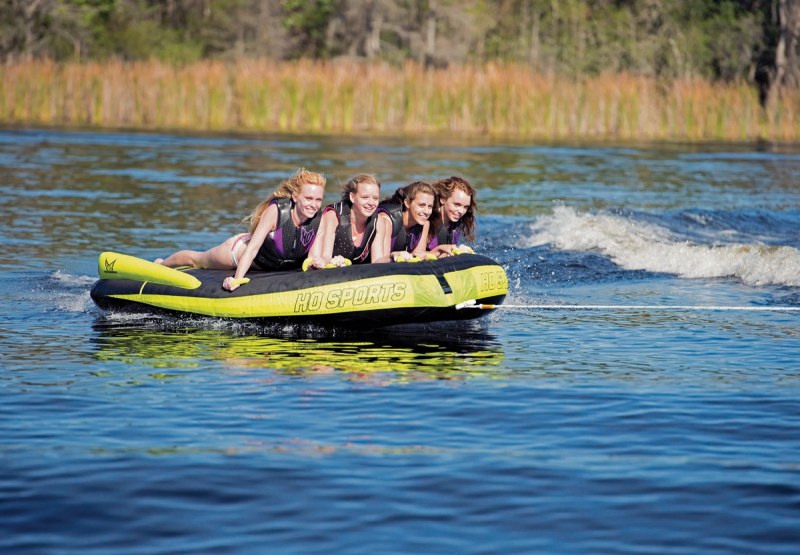 Tow Point
Never use a tow tower or center-mount ski tow to tow a tube! Should the tube dive, the stress would be enormous. You can use a transom ski tow, or better yet, affix a bridle between transom rings. Inflate
Make sure you inflate your towable to its maximum pressure. A soft tube means a saggy cover, which catches the water rather than skim over it. Electric inflators are available in portable and built-in models, and allow 
for easy deflation and stowage as well. Safety
While it's always important to be aware of buoys, anchored boats and flotsam (like logs), this is especially true when towing tubers. Though some towables can be steered, they are in no way as maneuverable as skis or boards. And passive tube riders might be less aware than an athlete. Be extra careful. Connect
Select a rope rated at 1,500 pounds for single-rider tubes. Double-rider tubes require a rope rated for 2,300 pounds. For four riders, select a rope with a 4,150-pound rating. Six-rider ropes are rated at 6,000 pounds. Better towables feature a quick-disconnect tow point that makes hooking up easy.