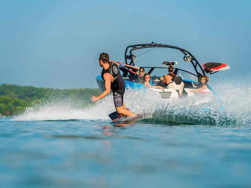 Wakeboarder behind a family boat