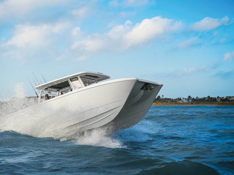 Twin Vee 400 GFX2 cresting over waves