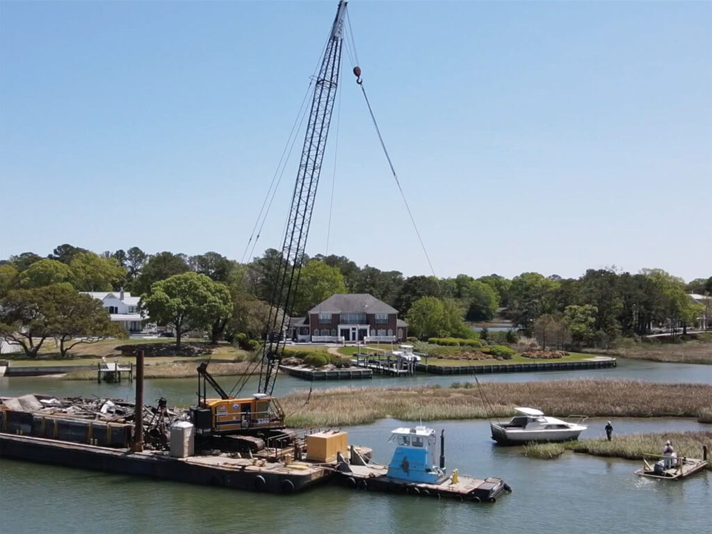 Crane removing abandoned boat