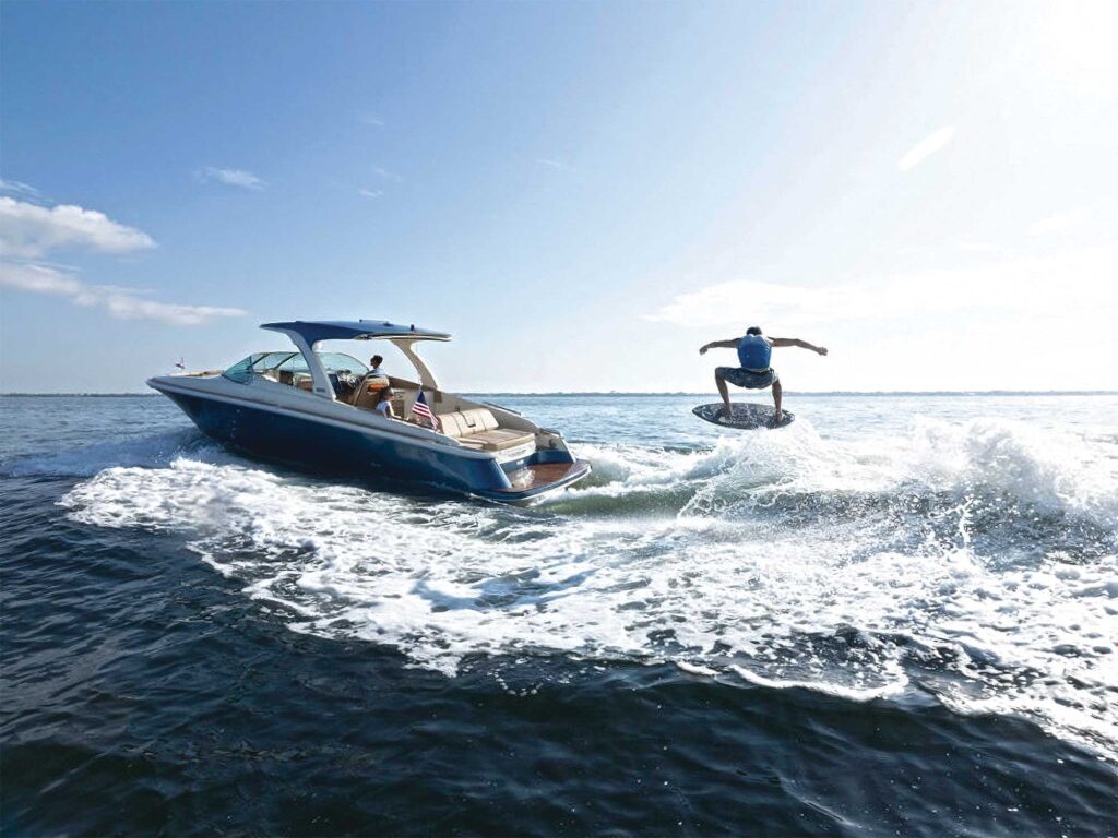 Chris-Craft Launch 35 GT Wake Surf Edition boosting a wakeskater