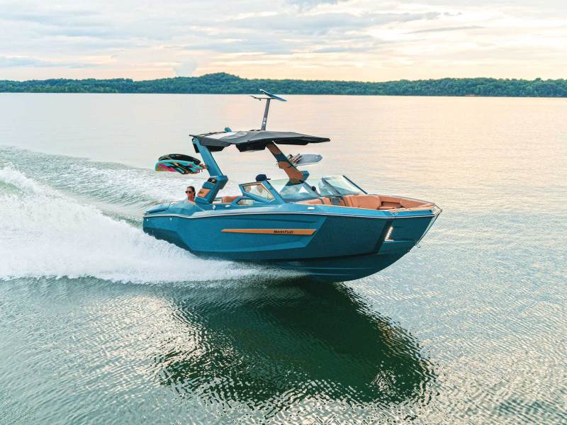 MasterCraft X24 on a glassy lake
