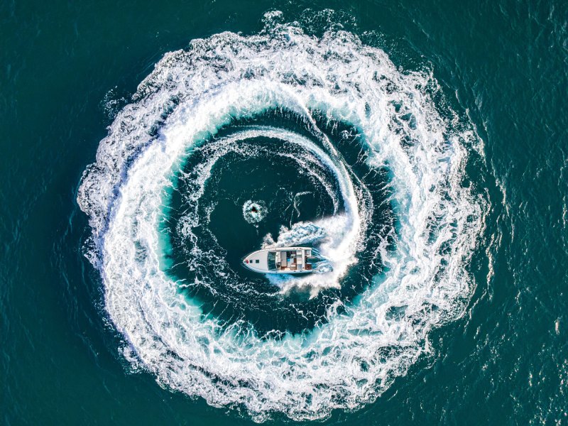 Boat circling a man overboard