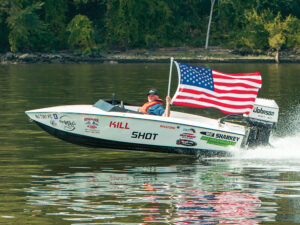 Tim Sharkey running in the river with American flag