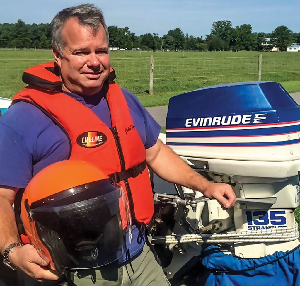 John Tiger next to outboard motor