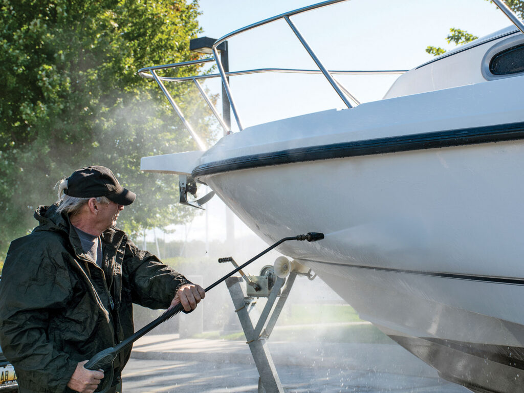Cleaning boat with pressure washer