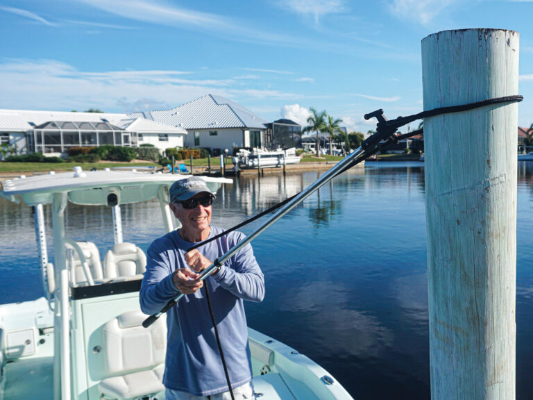 Boater using a boat hook