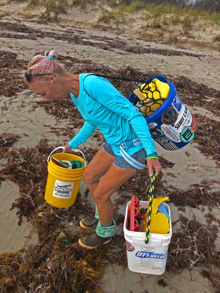 Cory Redwine cleaning the beach