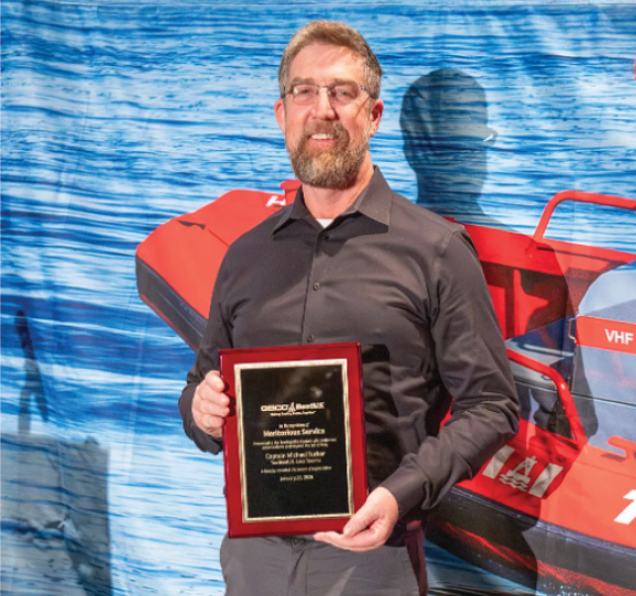 Capt. Michael Tucker receiving his Meritorious Service Award