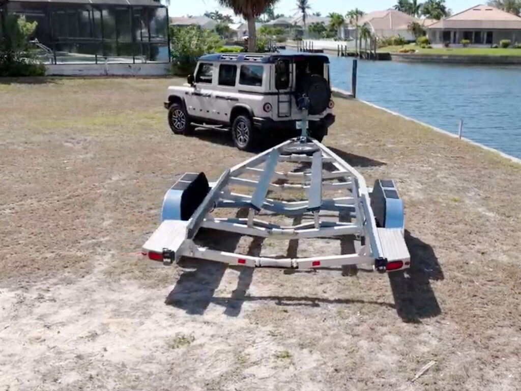 SUV backing up a boat trailer