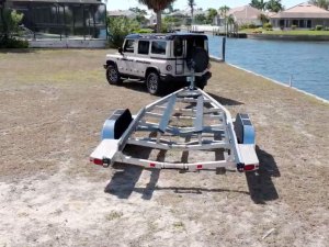 SUV backing up a boat trailer