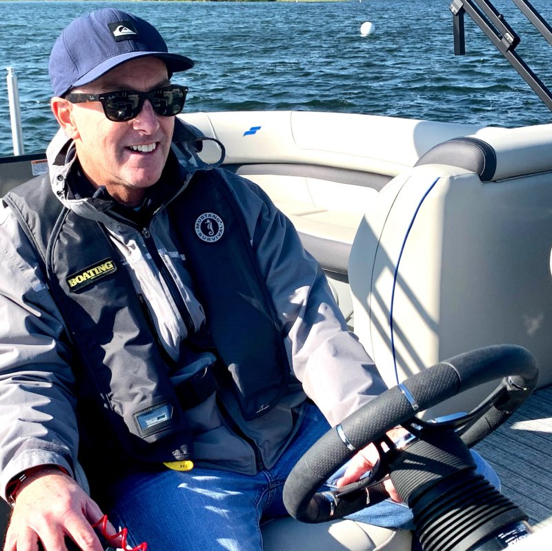 Boat driver wearing inflatable life jacket