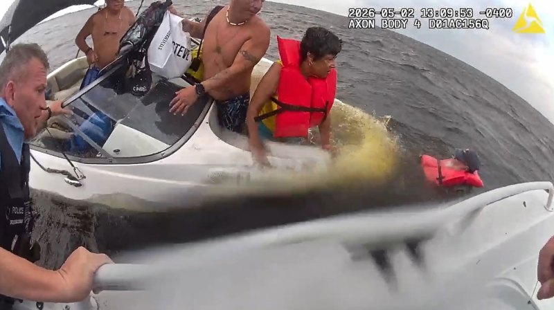 Officers rescuing family in sinking boat