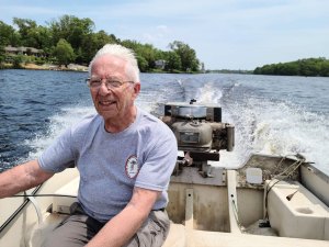 Robert W. Grubb at the helm of a classic boat